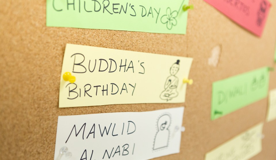bulletin board full of names of different religious celebrations around the globe