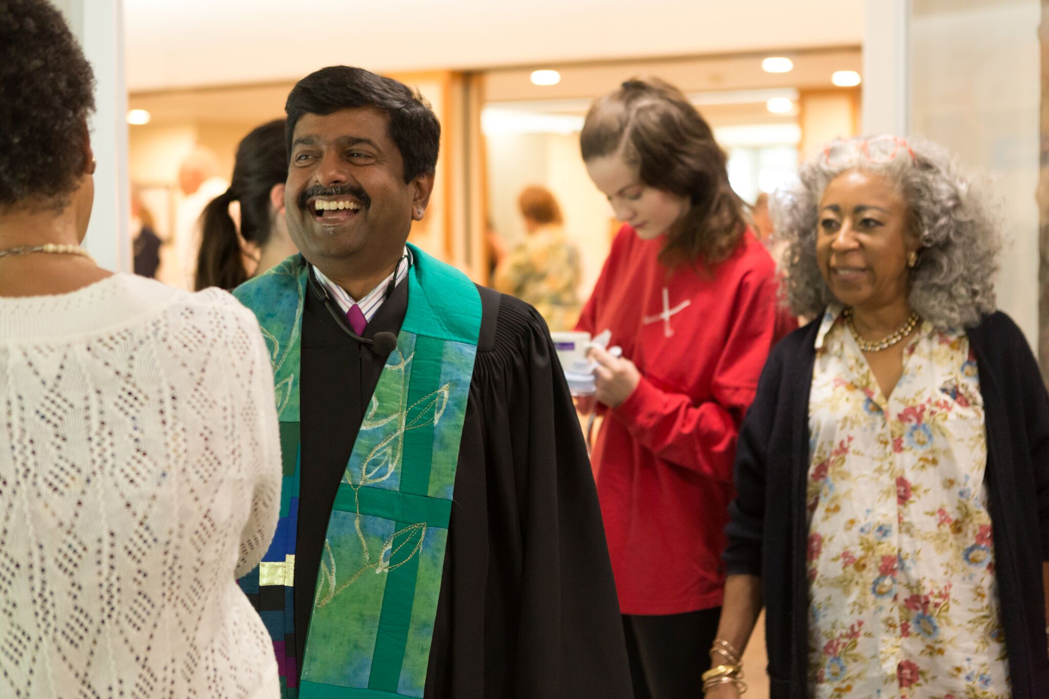 Senior Minister Abhi Janamanchi greets people in the church.