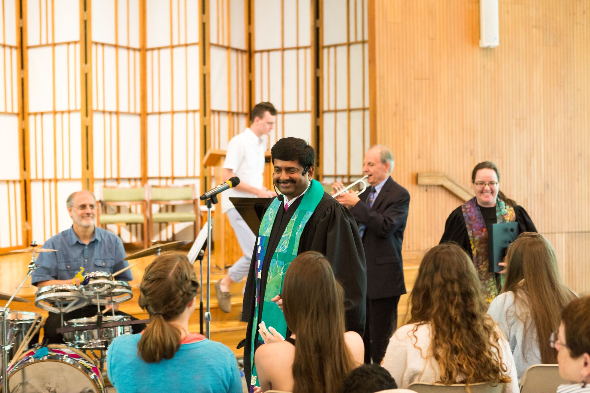 Senior Minister Abhi Janamanchi smiles at crowd.
